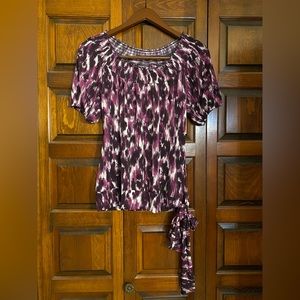 Multi-purple short-sleeve top. Shirred neckline. Band at waist w/left-side tie.
